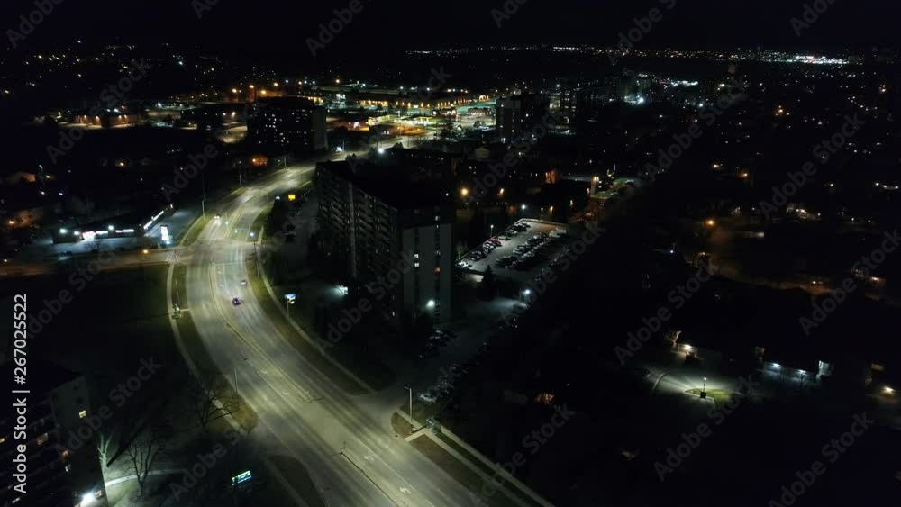 Front Multiple Cars Driving On Freeway At Night Through Town Aerial Front Multiple Cars Driving On Freeway At Night Through Town Aerial