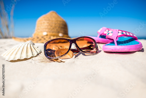 Summer vacation accessories on the beach. Holiday background.