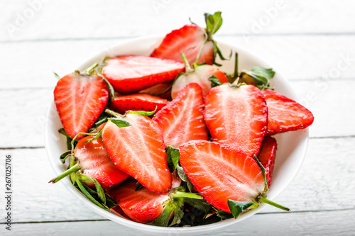 Fresh strawberries. Plate with juicy strawberry salad, sliced fruit