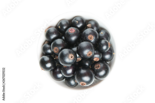 Black currant berries isolated on white background. Top view