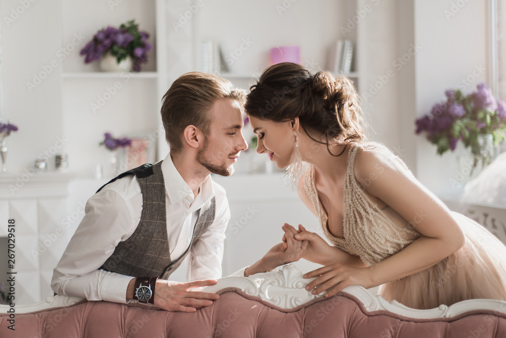 Happy tenderness couple in stylish interior. Well-dressed couple in love hugging in luxury hotel room Happy tenderness couple in stylish interior. Well-dressed couple in love hugging in luxury hotel room