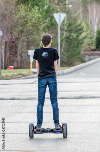 Boy teen rides on a giroskitter