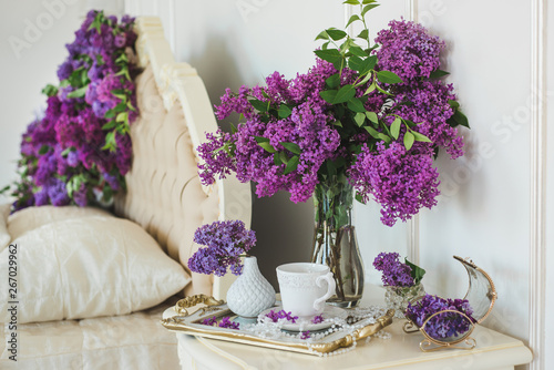Closeup of lilac floral composition in luxury bedroom interior. Bridal morning decorations