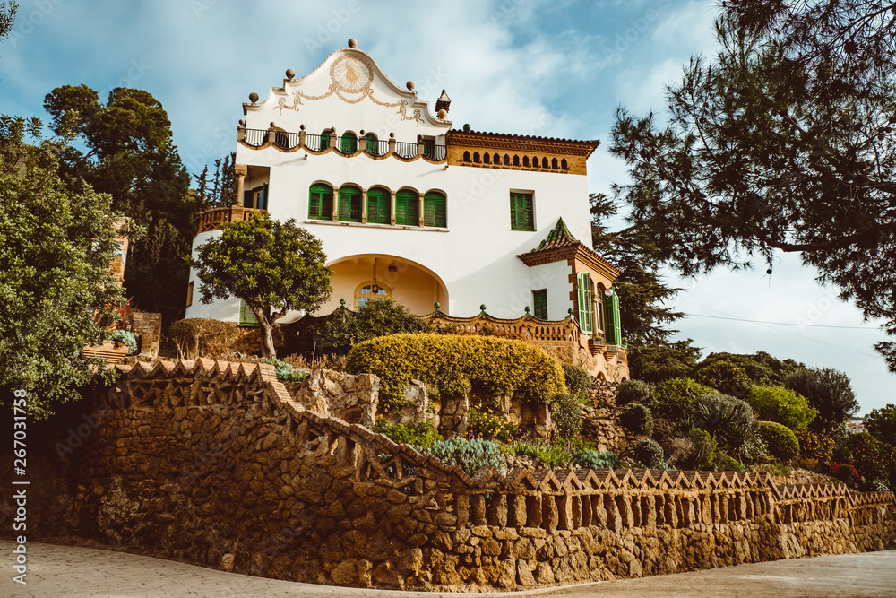 House with a sundial in the Parc Guell. Park Guell was designed by Antoni Gaud . In 1984