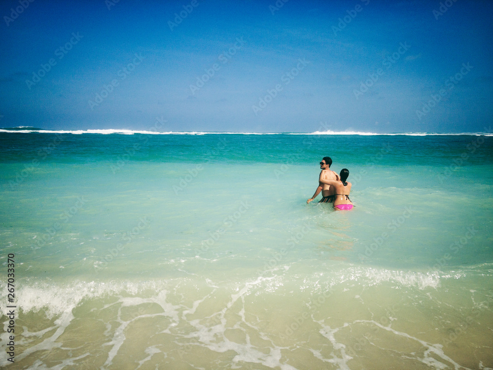 Couple enjoying on a sandy ocean tropical beach. Couple enjoying on a sandy ocean tropical beach.