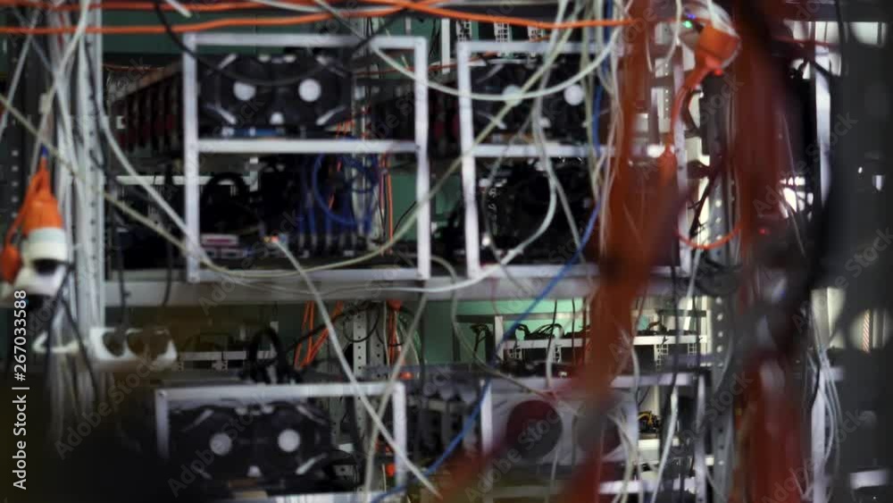Mining farm for cryptocurrency, electronic devices with wires and cables. Stock footage. Mining bitcoins and cryptocurrency.
