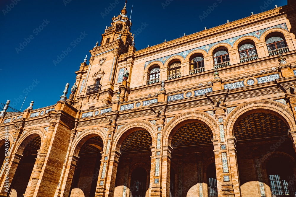 Facades of buildings on the Spanish square or the Plaza de Espana. Andalusia.