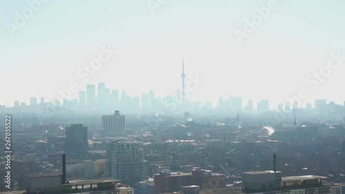 Zooming in to Toronto skylineZooming in, we see the Toronto skyline with CN tower in a haze, forming a silhouette of the buildings in the downtown core.