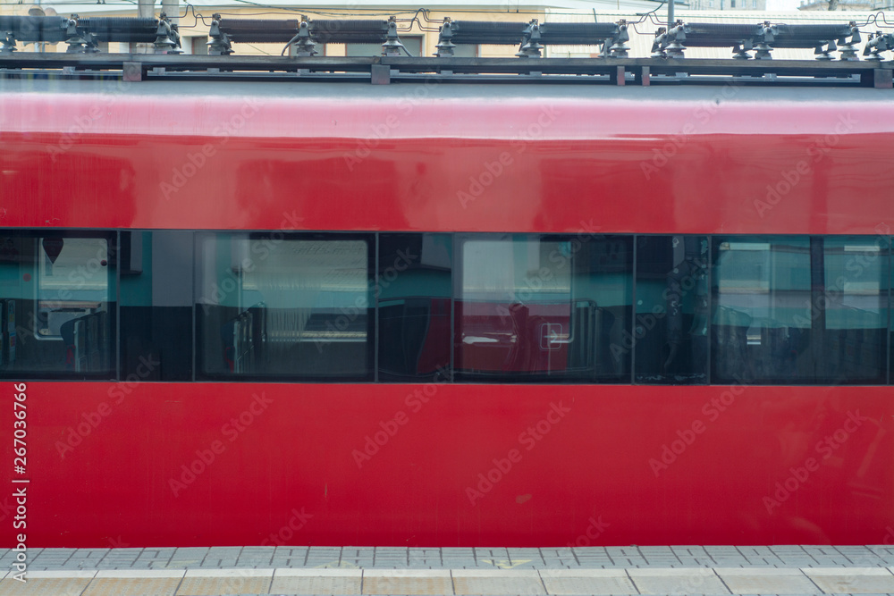 Passenger car of the train of red color on the platform Passenger car of the train of red color on the platform