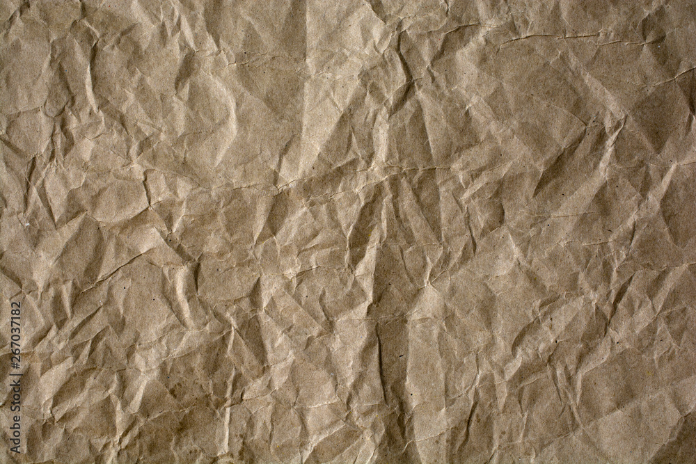 Fototapeta premium Background of rough crumpled paper. Abstract textural surface.