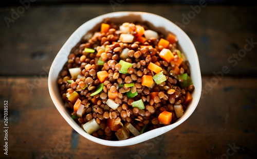 Rustic bowl of boiled lentils and vegetables photo