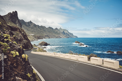 Scenic ocean road by the cliffs of the Macizo de Anaga mountain range, color toning applied, Tenerife, Spain. photo