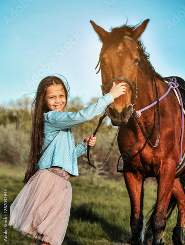 Beautiful girl with horse on the grass. Friendship concept. © Alona