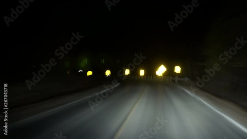 Driving down rural highway in pitch black night timelapse loopRunning from the law down a dark country highway, twisting and turning left and right. The night is dark and the road is long. Loop