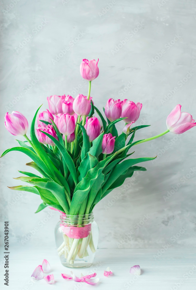 Bouquet of lilac fading tulips on a gray background. Bouquet of lilac fading tulips on a gray background.