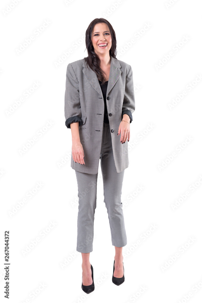 Relaxed fashionable business woman in checked suit laughing with arms down. Full body isolated on white background. Relaxed fashionable business woman in checked suit laughing with arms down. Full body isolated on white background.