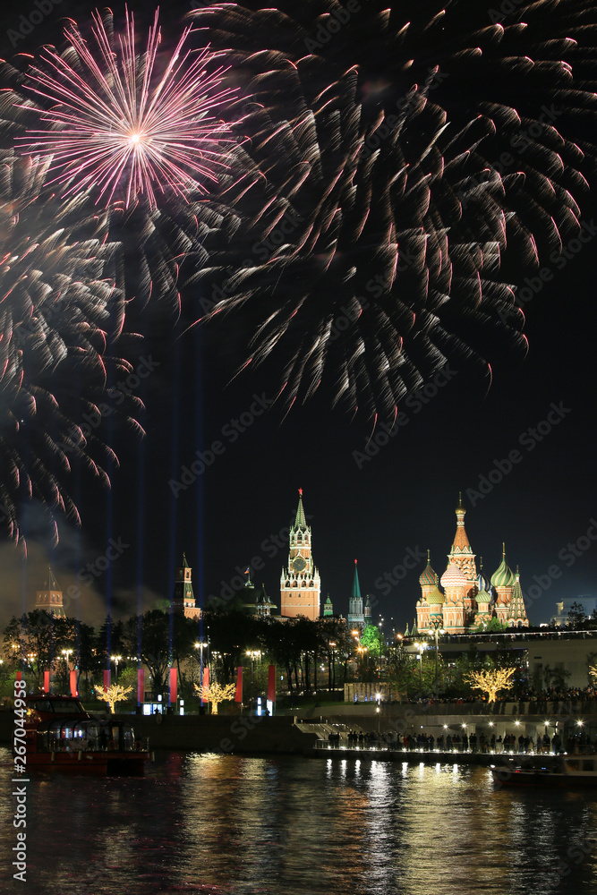 Beautiful evening view of the Moscow Kremlin and the holiday fireworks in the sky over Red Square, Russia