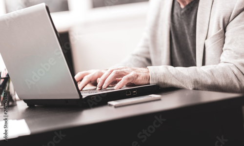 Hands of businessman using laptop