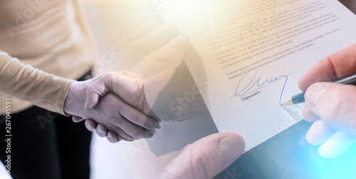 Signing of a contract and handshake; multiple exposure