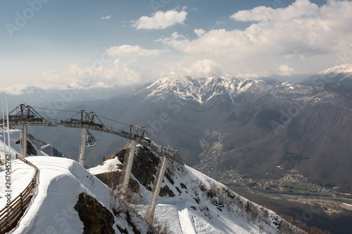 Aerial photography. Cable car to the top of the snow-covered mountain Aibga. Ski resort Krasnaya Polyana, Sochi. Vacation in the mountains. The view from the top.