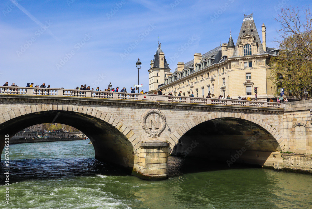 Paris / France - April 05 2019: Bridge Pont Saint-Michel across Seine River and  beautiful historic buildings of Paris