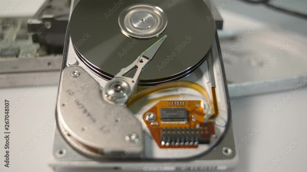 Disassembled hdd reading head. Hard disk drive initialization.