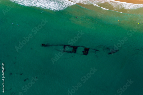 Leinwand Poster aerial view of a shipwreck at Wategoes Beach in Byron Bay