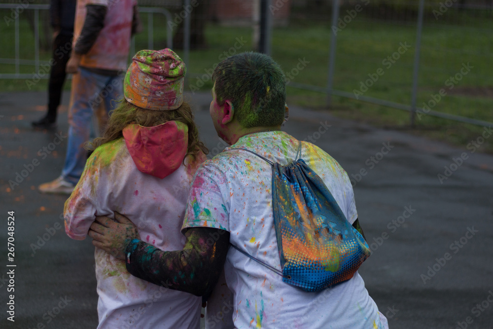 People celebrating Colors Holi festival. Beautiful happy young people. Holi india design concept.