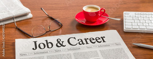 A newspaper on a wooden desk - Job and Career