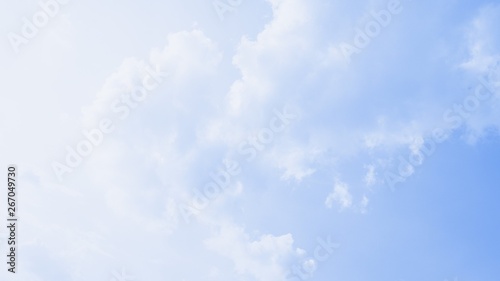 Scenic soft light sky. Beautiful white soft fluffy clouds on a blue sky background. 16 9 panoramic format