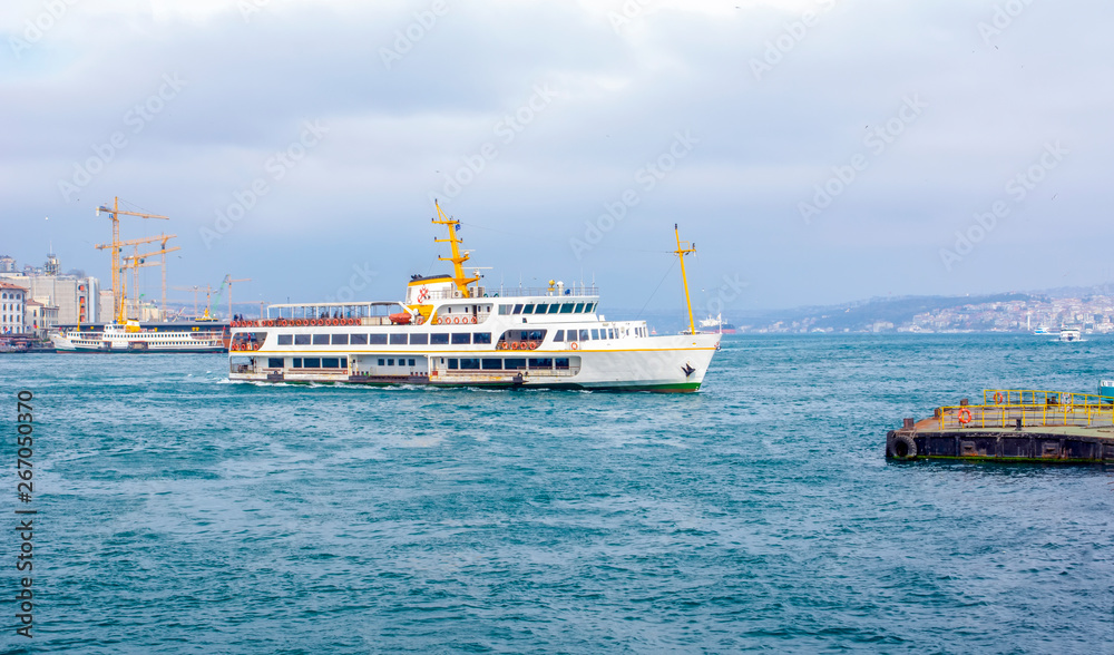 Muslim architecture and water transport in Turkey - Beautiful View touristic landmarks from sea voyage on Bosphorus. Cityscape of Istanbul at sunset - old mosque and turkish steamboats, view on Golden