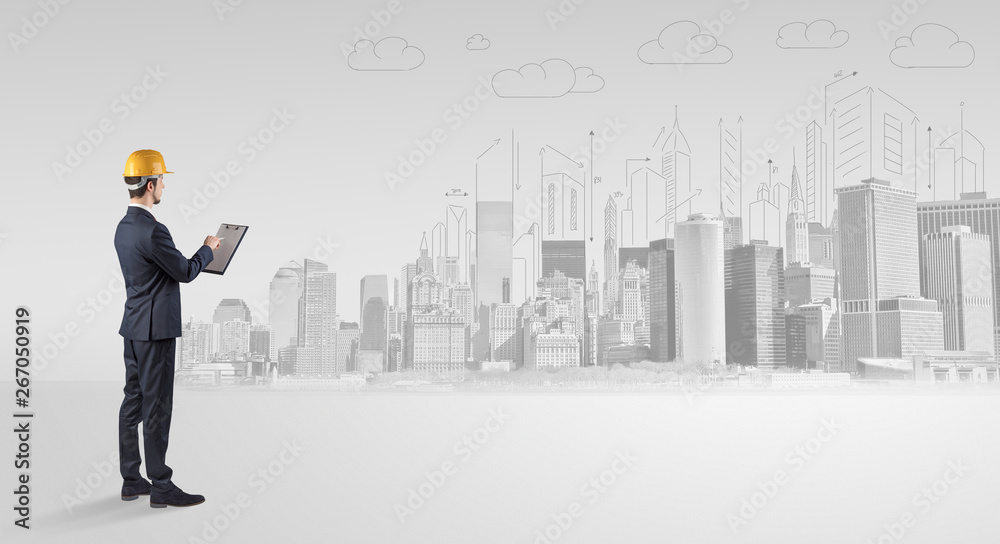 Young supervisor architect standing and replanning a big city panorama
Young supervisor architect standing and replanning a big city panorama