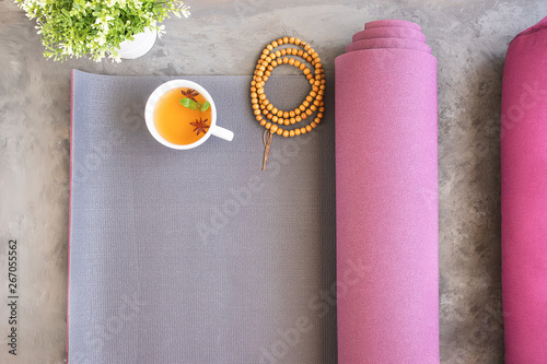 Open yoga mat and bolster for practice, wooden mala beads for metitation , Ayurveda tea for relax