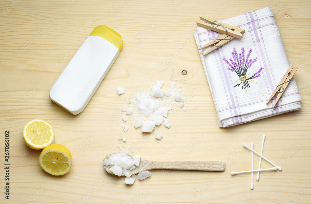 Eco friendly natural cleaners, washing soda, lemon, crystalic salt on a wooden background. Europe, Czech republic, Eco friendly natural cleaners, washing soda, lemon, crystalic salt on a wooden background. Europe, Czech republic,