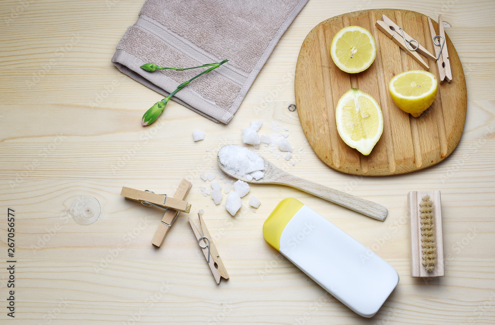 Eco friendly natural cleaners, washing soda, lemon, crystalic salt on a wooden background. Europe, Czech republic, Eco friendly natural cleaners, washing soda, lemon, crystalic salt on a wooden background. Europe, Czech republic,