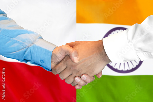 Business handshake on the background of two flags. Men handshake on the background of the Poland and India flag. Support concept