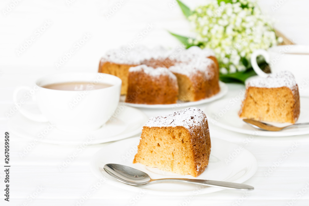 Bundt cake with sugar frosting. Spring breakfast set. Morning tea with flowers. Selected focus