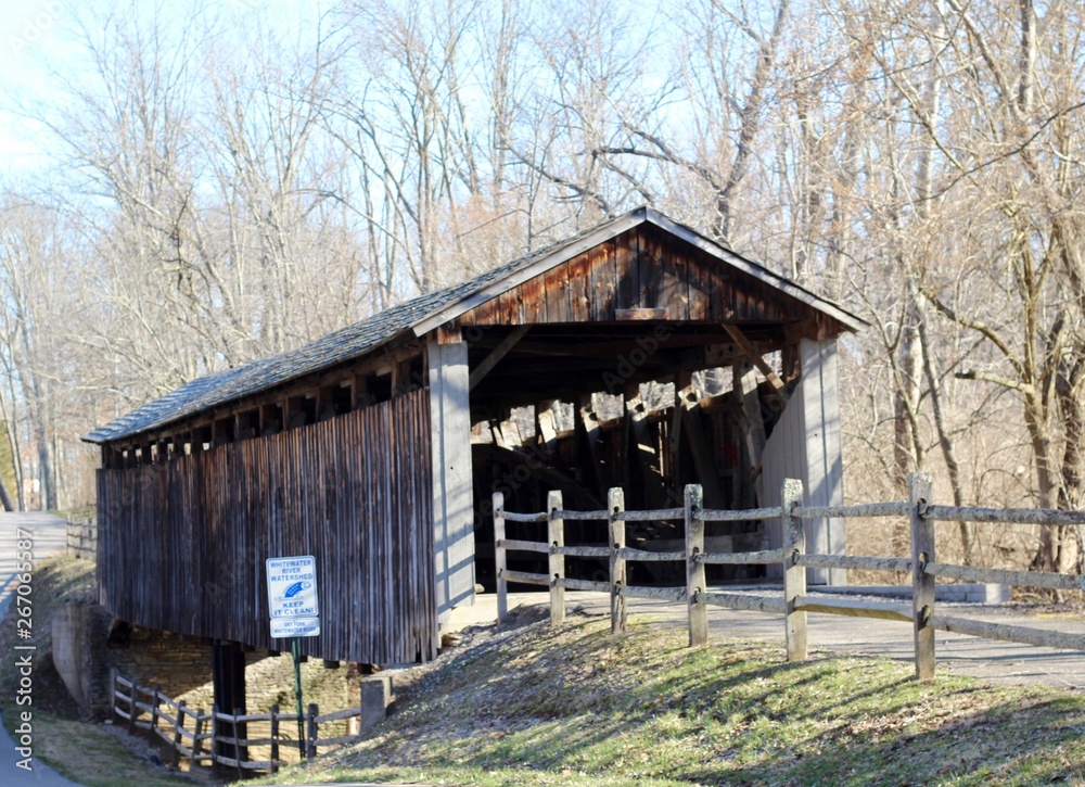 A view of the old wood covered bridge in the park. A view of the old wood covered bridge in the park.