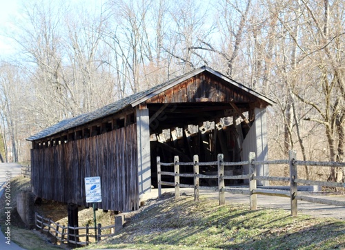 A view of the old wood covered bridge in the park. © Al