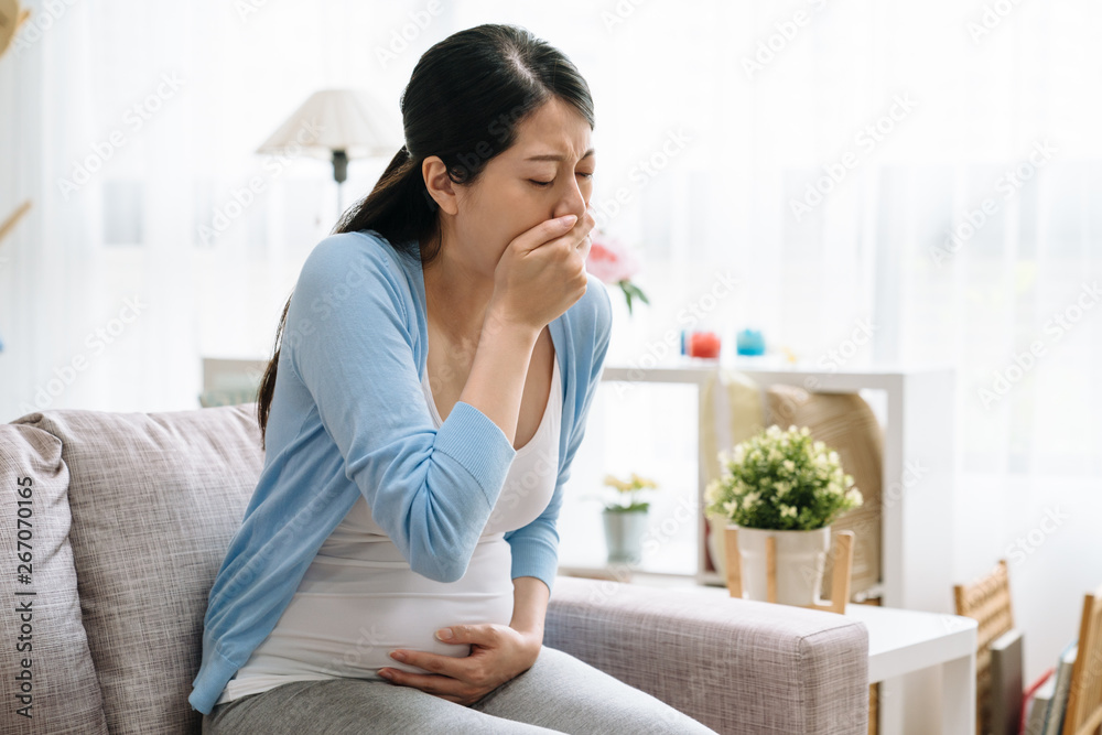 Young ill pregnant female have sore throat in winter. Causes of cough include common cold flu respiratory tract infection pneumonia bronchitis allergy asthma. motherhood healthcare sickness concept Young ill pregnant female have sore throat in winter. Causes of cough include common cold flu respiratory tract infection pneumonia bronchitis allergy asthma. motherhood healthcare sickness concept