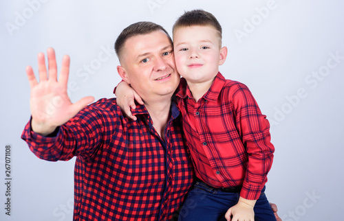 little boy with dad man. father and son in red checkered shirt. fathers day. happy family. childhood. parenting. Smiling cowboy. On the way to her dreamland. say hi to mom. Carefree time together