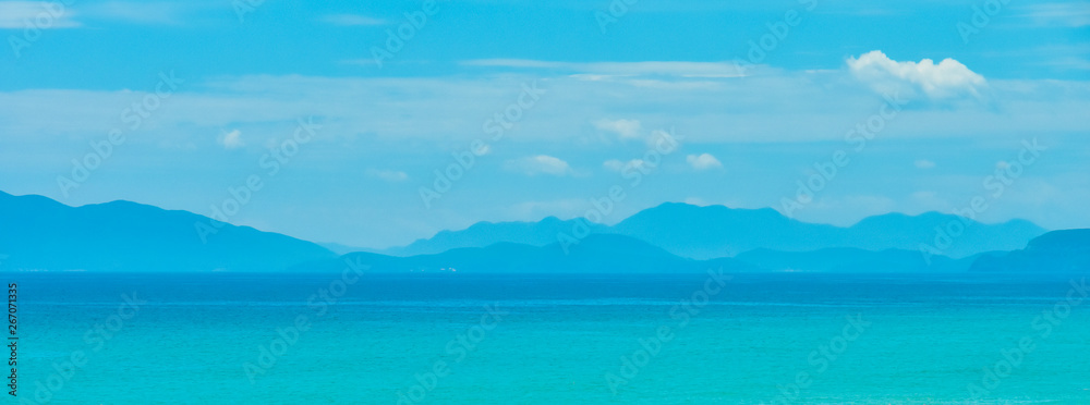 blue warm landscape background tropical sea mountains silhouettes. Copy space for text