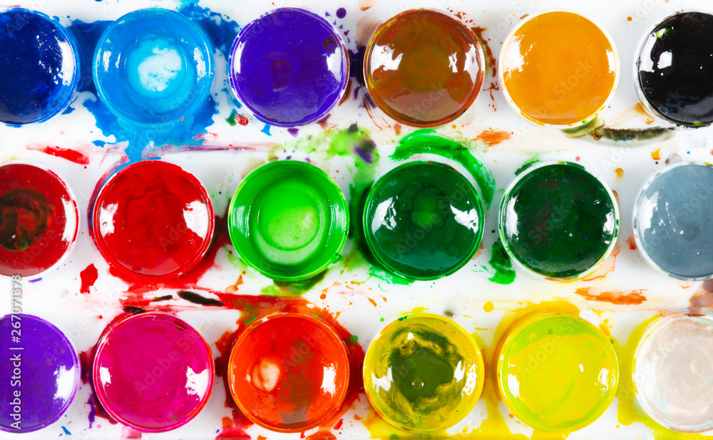 A set of children's paints in circular forms close-up