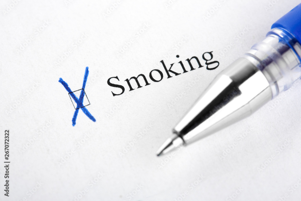 Smoking. Filling in the questionnaire, documents. The checkboxes are filled with a black pen on a white background. Questionnaire, survey.