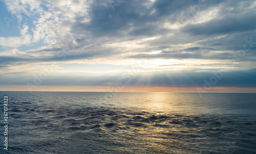 flying over the sea towards sunset