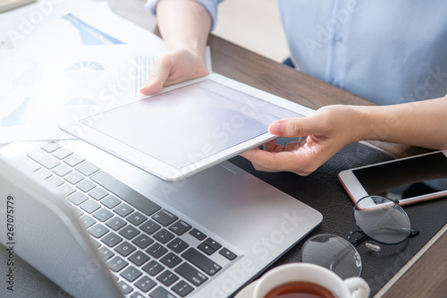 Business concept. Woman using tablet for project with digital device in office desk. Backlighting, sun glare effect, close up, side view, copy space