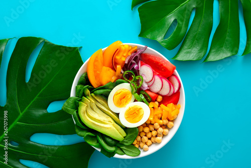 Buddha bowl with boiled eggs served on monstera leaves