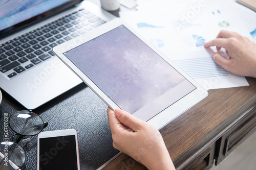 Business concept. Woman using tablet for project with digital device in office desk. Backlighting, sun glare effect, close up, side view, copy space