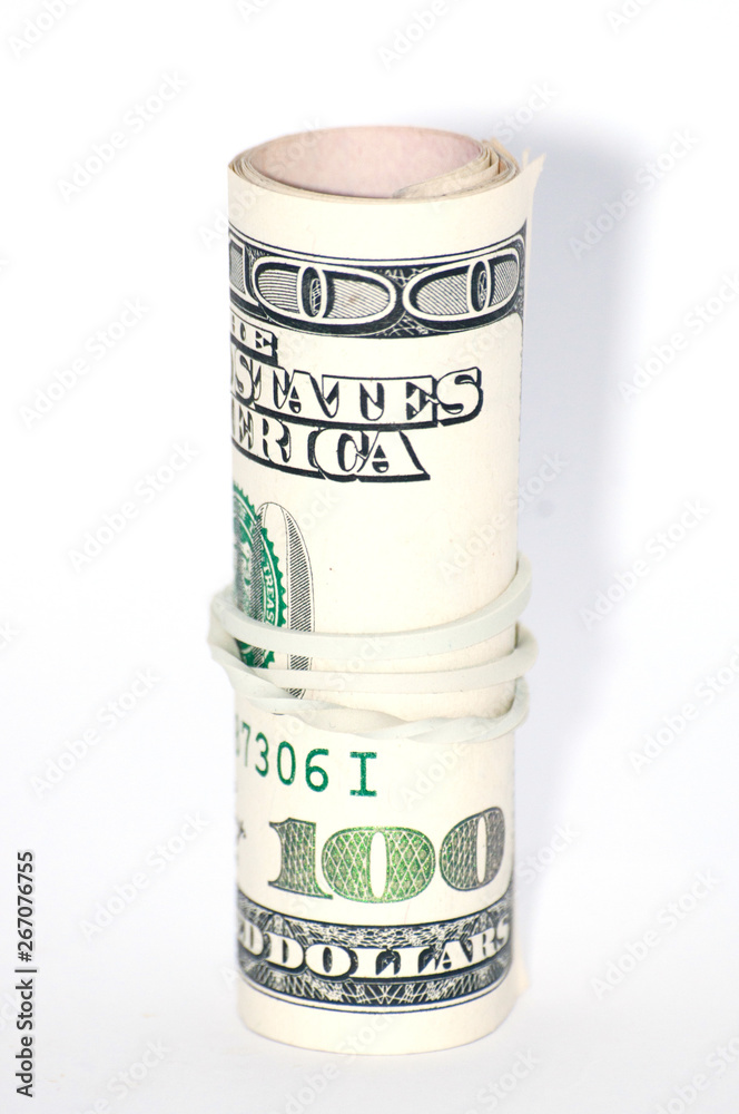 Money on a white background, one hundred dollars close-up rolled into a tube Money on a white background, one hundred dollars close-up rolled into a tube