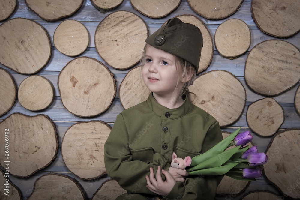 a small child in military uniform for the victory Day holiday